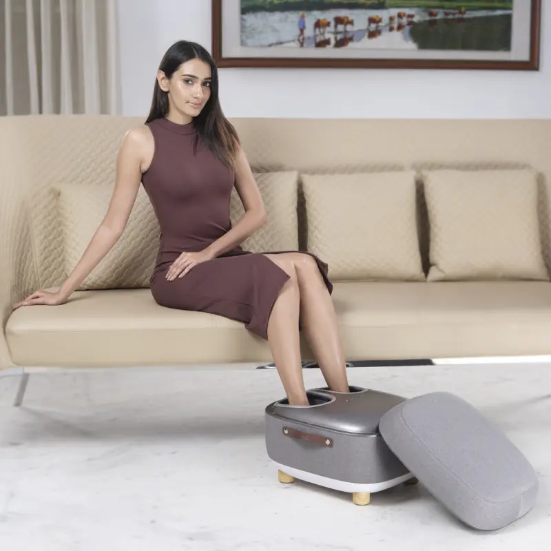 Woman Sitting on Sofa and taking leg massage on LI650 Foot Massager