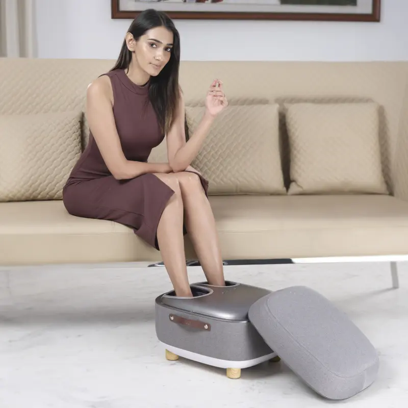 Woman Sitting on Sofa and taking massage on LI650 Foot Massager